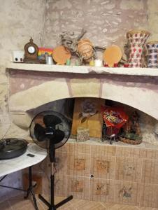 a kitchen with a stone fireplace with a stove at School1922 in Krousón +109 photos