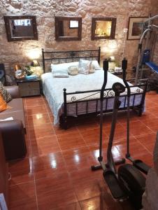 a bedroom with a bed and two exercise bikes at School1922 in Krousón