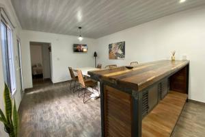 a room with a counter and a table with chairs at SH Aparts Depto 1 in Coronel Suárez +4 photos