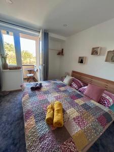a bedroom with a bed with two yellow socks on it at Villa Montis in Vysoké Tatry