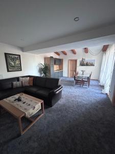 a living room with a couch and a table at Villa Montis in Vysoké Tatry