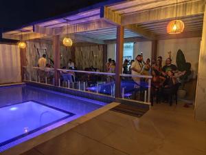 a group of people standing around a swimming pool at Pousada MK TOUR in Pedra de Guaratiba +44 photos