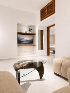a living room with a glass table and a couch at Silver Apartment Abidjan in Abidjan