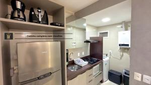 a small kitchen with a stainless steel refrigerator at Vg Fun by Diego Flats in Fortaleza