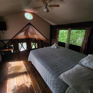a bedroom with a bed with a cat sitting on it at Eco Aldea kinich Ahau Calakmul in Xpujil