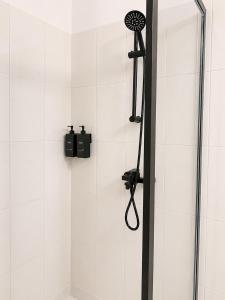 a shower with a shower head in a bathroom at Silver Apartment Abidjan in Abidjan