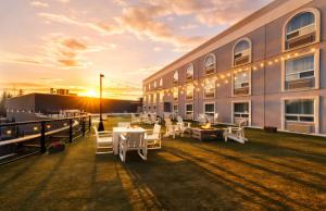 a building with tables and chairs in front of it at Prestige Treasure Cove Resort in Prince George