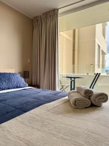 a bedroom with a bed with towels on it at Alto Arrayán in Osorno