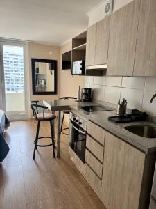 a kitchen with a counter and a table with a sink at Alto Arrayán in Osorno +50 photos