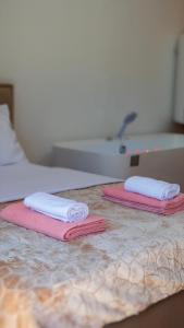 two towels sitting on top of a bed at Arditis Cozy Studio in Bogë