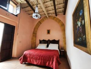 a bedroom with a bed with a red blanket at Roccamelia Experience in Mazara del Vallo +61 photos