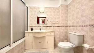 a bathroom with a toilet and a sink at Apartamento sto estavão 2 in Zambujeira do Mar