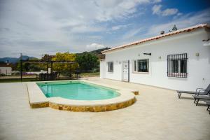 a swimming pool in front of a house at Finca Tres Aguas, Casa Rural con Piscina Privada in Lanjarón