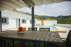 a table with a bowl of fruit on top of a house at Finca Tres Aguas, Casa Rural con Piscina Privada in Lanjarón
