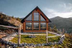 a cabin in the mountains with a large window at Mountain Dream Chalet Durmitor in Nedajno