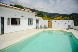 a swimming pool in front of a white house at Finca Tres Aguas, Casa Rural con Piscina Privada in Lanjarón +30 photos