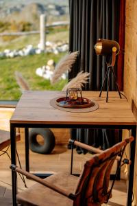 a wooden table with a plate on top of it at Mountain Dream Chalet Durmitor in Nedajno