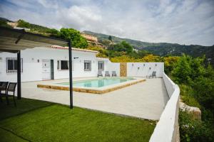 a house with a swimming pool in a yard at Finca Tres Aguas, Casa Rural con Piscina Privada in Lanjarón