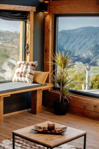 a room with a bench and a table and a window at Mountain Dream Chalet Durmitor in Nedajno