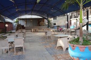 a patio with tables and chairs and a building at Zions Apartments in Elephant Island