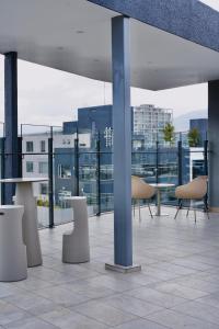 a balcony with chairs and tables on a building at Cielo Apartments with top amenities in Quito