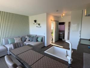 a living room with a couch and a table at Traum Ferienwohnung Kell am See in Kell