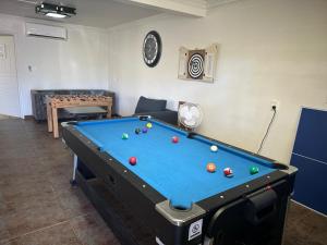 a living room with a pool table in a room at The KentiGate - much more than a room in Nuku‘alofa