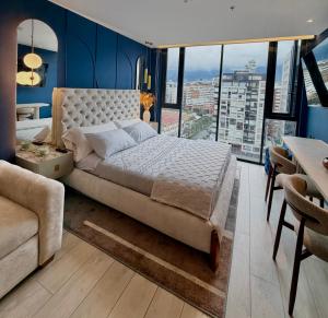 a bedroom with a large bed and a large window at Cielo Apartments with top amenities in Quito +65 photos