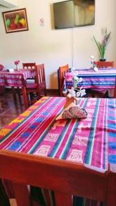 a table with a colorful table cloth on it at Misky Sonqo in Tilcara