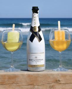 a bottle of wine and two glasses on the beach at Sun Suite in Sitia