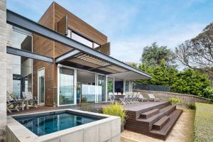 a house with a swimming pool and a patio at Emanjay - Mineral Spa, Million Dollar Views in Mount Martha