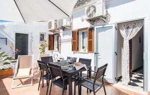 a dining room with a black table and chairs at Sa Fornera in Alcudia