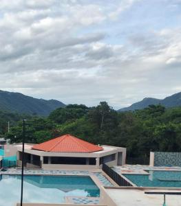 a view of a building with two swimming pools at Tangará real 204 in Apulo