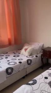 a small bedroom with a bed and a table at Tangará real 204 in Apulo