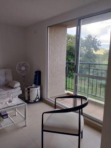 a living room with a couch and a large window at Tangará real 204 in Apulo +1 photo