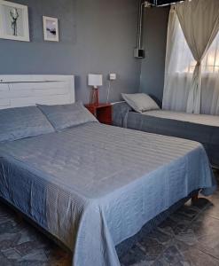 a bedroom with two beds and a window at Alojamiento RuOli in Valle Hermoso