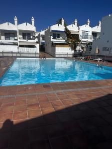 a large swimming pool in front of a building at Casa De Pablo - Marbella Golf in Maspalomas