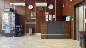 a store with clocks on the wall and a counter at شقق زهرة النزلاء المخدومة الخرج in Al Kharj