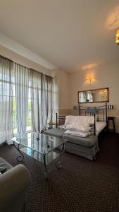 a bedroom with a bed and a glass table at Summertime Suites in Łagów