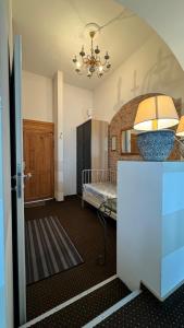 a room with a bedroom with a bed and a chandelier at Summertime Suites in Łagów