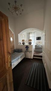 a bedroom with a bed and a couch in a room at Summertime Suites in Łagów