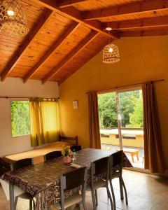 a dining room with a table and chairs and a window at Posada del Guardián in Villa Yacanto