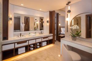 a bathroom with two sinks and a large mirror at Moon Palace The Grand Cancun All Inclusive in Cancún