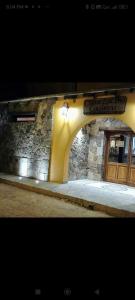 a building with a stone wall and a doorway at Cielo Andino Colonial in Purmamarca