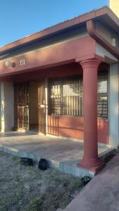 a building with a red pole in front of it at Hyponia 1512 in Oshikuku