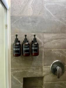 three bottles of soap on a wall in a shower at Jazz & Stay in Guadalajara +36 photos