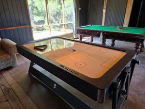 a ping pong table in a room with a pool at Kangaroo Lake C & V Park in Mystic Park