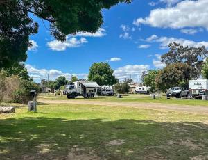 a group of rvs parked in a park at Kangaroo Lake C & V Park in Mystic Park
