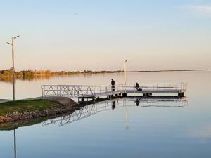 two people standing on a dock on a lake at Kangaroo Lake C & V Park in Mystic Park +4 photos