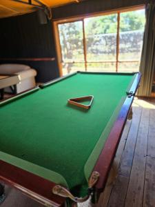 a green pool table with a cue ball on it at Kangaroo Lake C & V Park in Mystic Park
